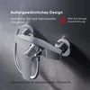 A close-up studio shot of a chrome shower faucet mounted on a textured gray wall. Produktbild-Vorschau