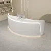 A modern white reception desk with integrated lighting, placed on a tiled floor in a clean, minimalist setting. Produktbild-Vorschau