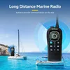A marine radio is shown in the foreground with two sailboats in the background on a bright, sunny day. Anteprima dell’immagine prodotto