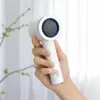 A hand holding a white electric callus remover. Produktbild-Vorschau