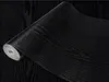 A roll of black wood-grain wallpaper. Produktbild-Vorschau