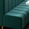 A close-up view of a dark green upholstered bench with a fluted backrest and a smooth seat. Anteprima dell’immagine prodotto