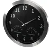 A close-up, angled view of a black analog clock with a silver frame, showing the time and integrated thermometer and hygrometer. Anteprima dell’immagine prodotto