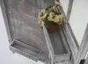 A close-up view of a decorative wooden room divider with plant boxes and artificial flowers. Voir les images du produit