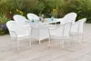 An outdoor dining set with chairs and a table on a patio, surrounded by plants and flowers. Produktbild-Vorschau