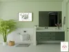 A modern bathroom with green accents, featuring a toilet, vanity, and artwork. Produktbild-Vorschau