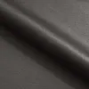 A close-up, angled view of dark gray fabric, likely upholstery, with soft lighting highlighting the texture and folds. Produktbild-Vorschau