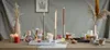 A table setting with candles, diffusers, and decorative elements. Produktbild-Vorschau