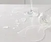 A close-up of a white, textured surface with water droplets and a glass lying on its side. Voir les images du produit