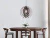 A dining room setting with a wooden table and chairs, and a pendant light fixture hanging above. Náhled obrázku produktu