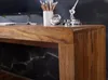 A close-up of a wooden desk with a marble-patterned background. Produktbild-Vorschau