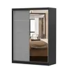 A wardrobe with mirrored doors reflecting a bedroom interior. Voir les images du produit