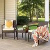 Two chairs and a small table on a patio with trees and bushes in the background. Produktbild-Vorschau