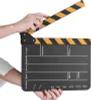 A hand holding a film clapperboard. Náhled obrázku produktu