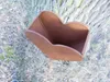 A heart-shaped garden stake with a planter attached, standing in the ground next to a tree. Produktbild-Vorschau