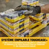 A hand in a glove is stacking yellow and clear plastic toolboxes. Produktbild-Vorschau