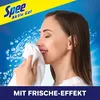 A woman is smelling a towel while bubbles and water splash around her. Náhľad obrázku produktu