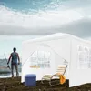 A person is fishing by a lake next to a white party tent with a lounge chair and cooler. Voir les images du produit