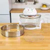 A halogen oven and its accessories are displayed on a wooden countertop in a kitchen setting. Podgląd zdjęcia produktu