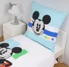 A close-up view of a Disney Mickey Mouse themed duvet cover and pillowcase set on a white bed. Produktbild-Vorschau