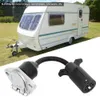A trailer adapter cable is shown in the foreground, with a caravan in the background. Podgląd zdjęcia produktu