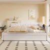 A modern bedroom with a white daybed, decorative pillows, and a rug. Náhled obrázku produktu