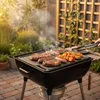 A barbecue grill with steaks, sausages, and skewers cooking on it in a backyard setting. Náhľad obrázku produktu