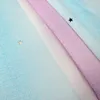 A close-up view of folded fabric with a gradient of colors and small star cutouts. Náhled obrázku produktu