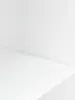 An empty white shelf and wall, suggesting a product display or studio setting. Náhľad obrázku produktu