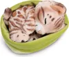 A plush toy cat sleeping in a green bed. Produktbild-Vorschau
