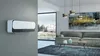 A modern living room with a wall-mounted heater, a sofa, a coffee table, and a large window overlooking a snowy landscape. Anteprima dell’immagine prodotto