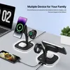 A desk with a laptop, a plant, and two charging stations for multiple devices, including phones, watches, and earbuds. Podgląd zdjęcia produktu