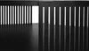 A close-up view of the black metal legs and slatted sides of a coffee table. Náhled obrázku produktu