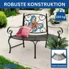A garden bench with a butterfly design on the back, placed outdoors on a patio with plants. Anteprima dell’immagine prodotto