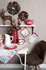 A festive Christmas display on a table and shelf. Produktbild-Vorschau