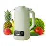 A light green soy milk maker is displayed prominently in the center, surrounded by various fresh fruits and vegetables like pineapple, bananas, apples, lettuce, tomatoes, and cucumbers. Anteprima dell’immagine prodotto
