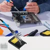 A person is soldering a circuit board with a soldering iron, surrounded by various soldering tools. Voir les images du produit