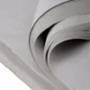 A close-up view of stacked gray tissue paper. Produktbild-Vorschau