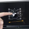 A close-up of a finger interacting with a control dial on a black appliance, likely an oven or cooktop, with various function icons displayed. Náhled obrázku produktu