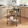 A kitchen scene with a rolling cart in the foreground and kitchen cabinets and a sink in the background. Anteprima dell’immagine prodotto