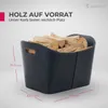 A dark gray log basket filled with firewood, with dimensions indicated by lines and text. Produktbild-Vorschau