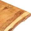 A close-up view of the edge of a wooden tabletop with a live edge. Podgląd zdjęcia produktu