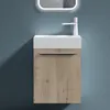 A modern bathroom vanity with a white sink and a wood-grain cabinet against a blue wall. Produktbild-Vorschau