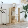 A bookshelf with books and a basket on it, next to a desk and a plant. Náhľad obrázku produktu