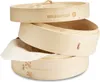 A stack of bamboo steamers with a piece of cloth sticking out of one. Produktbild-Vorschau