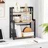 A three-tiered shelf unit on a desk, displaying various decorative items and books. Produktbild-Vorschau
