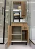 A bathroom vanity with a sink, mirror, and storage cabinets. Náhled obrázku produktu