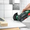 A hand is using a power tool to cut a tile in a bathroom setting. Voir les images du produit