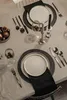 A table setting for a meal, possibly for a holiday or special occasion, with plates, cutlery, glassware, and decorative elements. Náhľad obrázku produktu