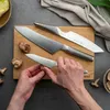 A close-up shot of hands preparing mushrooms with Global knives on a wooden cutting board. Produktbild-Vorschau